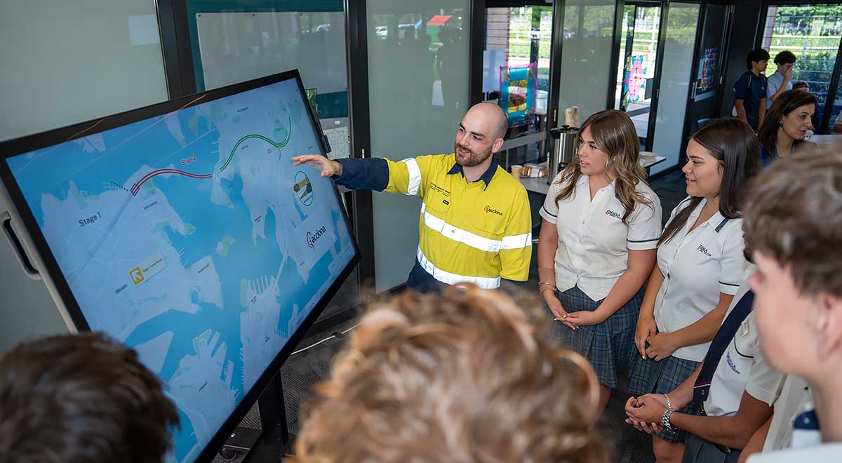 ACCIONA employee, Joshua Nagle, showing construction plans to Penola Catholic College students.